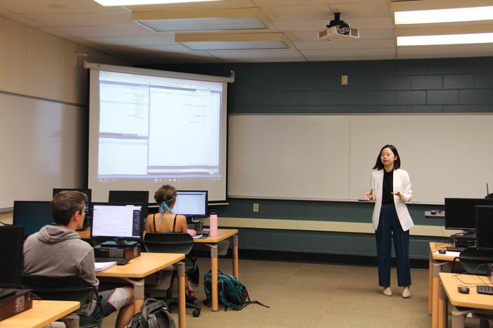 Professor teaching student in a computer class.
